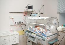 Newborn baby sleeping in an incubator